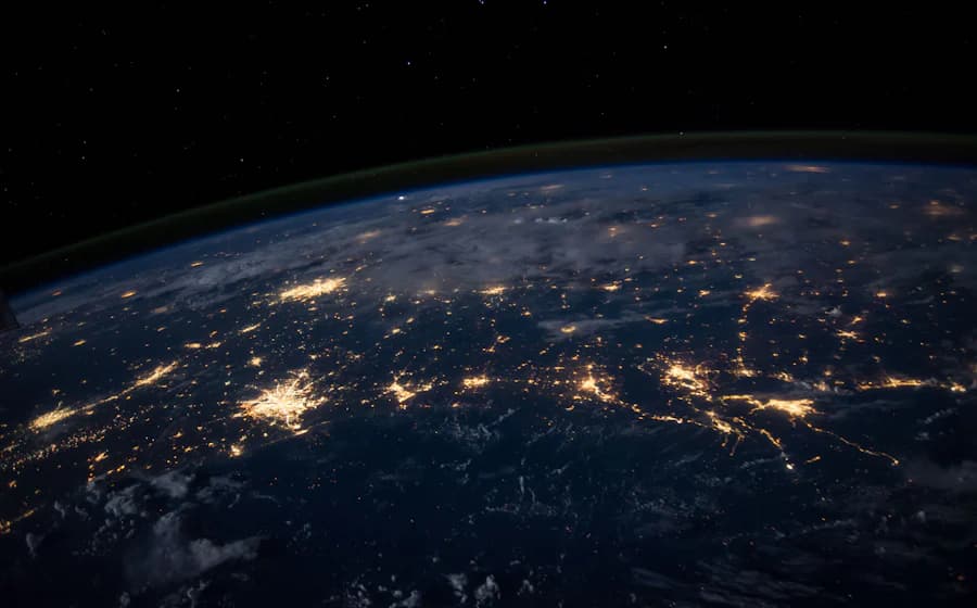 The curve of the Earth photographed from space at night, with city lights visible